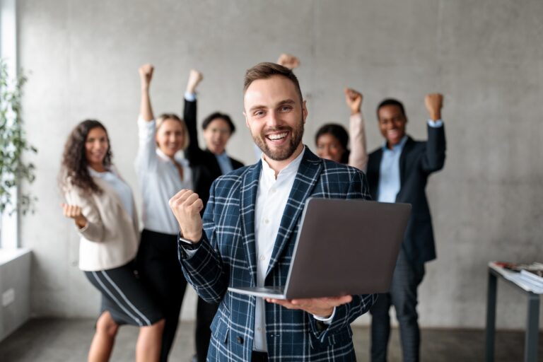 Joyful Businessman And His Team Celebrating Business Success In Office